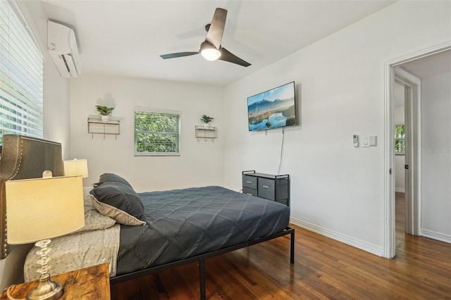 318 E Jersey St, Orlando, FL 32806 - bedroom with a wall mounted air conditioner, wood finished floors, baseboards, and ceiling fan
