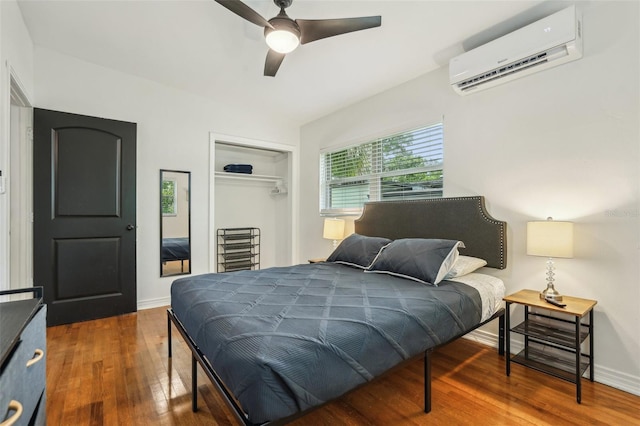 318 E Jersey St, Orlando, FL 32806 - bedroom with a wall unit AC, a closet, wood finished floors, ceiling fan, and baseboards