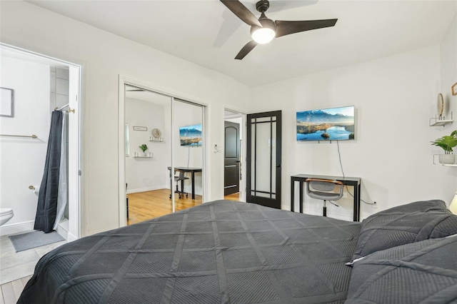 318 E Jersey St, Orlando, FL 32806 - bedroom featuring baseboards, a ceiling fan, ensuite bathroom, and wood finished floors