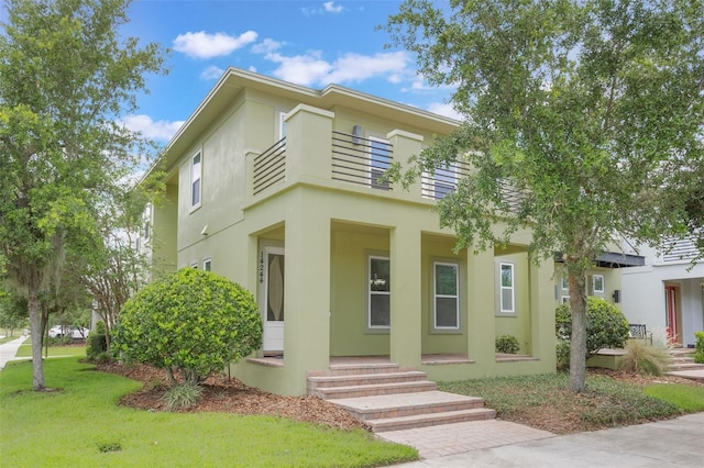 14244 Walcott Ave, Orlando, FL 32827 - view of front of house with stucco siding, a porch, and a front lawn