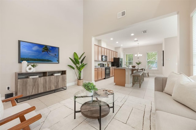 14244 Walcott Ave, Orlando, FL 32827 - living room featuring a chandelier, light tile patterned floors, a high ceiling, and recessed lighting