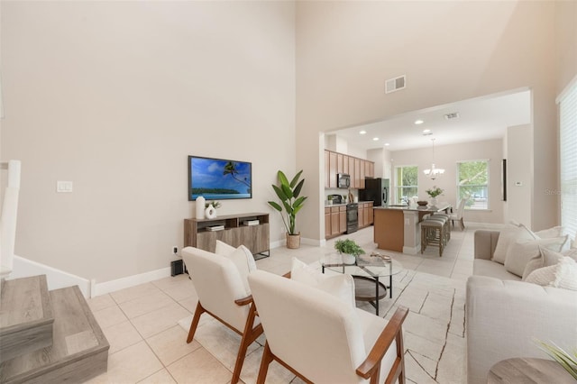 14244 Walcott Ave, Orlando, FL 32827 - living room with light tile patterned floors, a towering ceiling, a chandelier, and recessed lighting