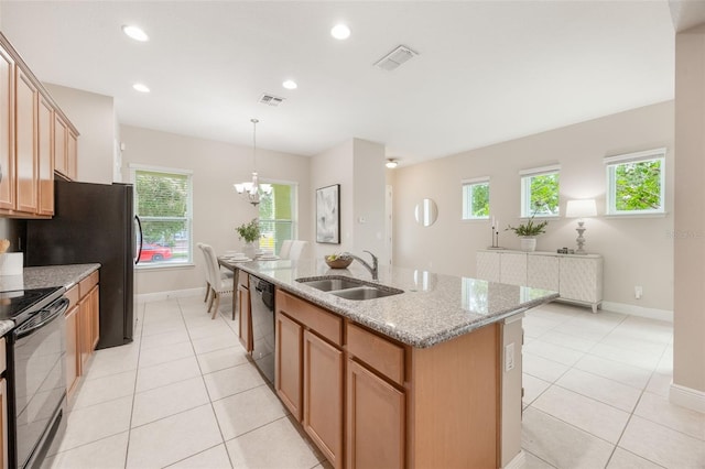 14244 Walcott Ave, Orlando, FL 32827 - kitchen with black appliances, a kitchen island with sink, healthy amount of natural light, light tile patterned floors, and recessed lighting