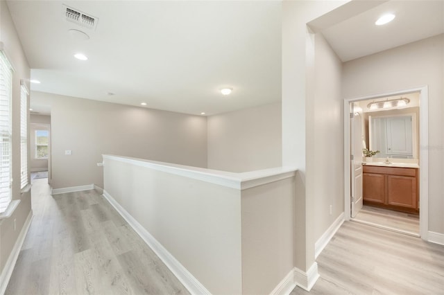 14244 Walcott Ave, Orlando, FL 32827 - corridor with an upstairs landing, light wood-style floors, and recessed lighting