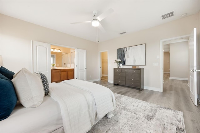14244 Walcott Ave, Orlando, FL 32827 - bedroom with light wood-type flooring, connected bathroom, and ceiling fan
