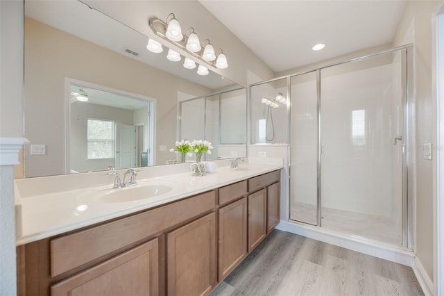 14244 Walcott Ave, Orlando, FL 32827 - full bathroom with double vanity, wood finished floors, and a stall shower
