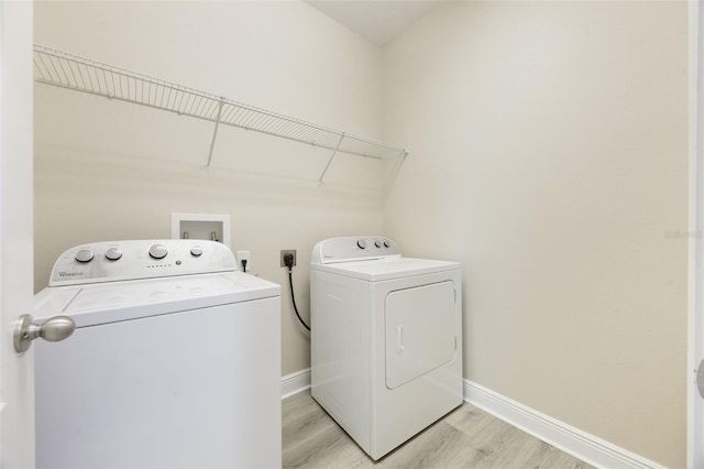 14244 Walcott Ave, Orlando, FL 32827 - laundry area featuring separate washer and dryer and light wood-style flooring