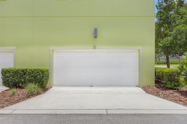 14244 Walcott Ave, Orlando, FL 32827 - garage featuring concrete driveway