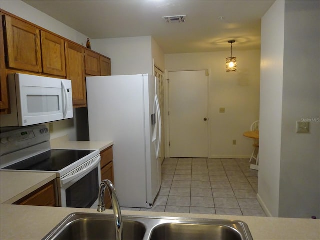 672 Post Oak Cir Unit 106, Altamonte Springs, FL 32701 - kitchen featuring white appliances, brown cabinets, light tile patterned floors, a sink, and light countertops