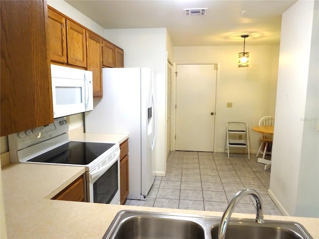 672 Post Oak Cir Unit 106, Altamonte Springs, FL 32701 - kitchen featuring white appliances, a sink, brown cabinetry, light countertops, and light tile patterned floors