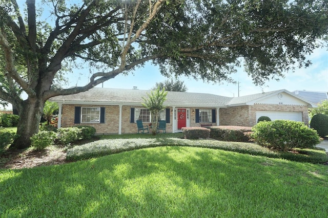 4141 Fallwood Cir, Orlando, FL 32812 - single story home with an attached garage, a front yard, and brick siding