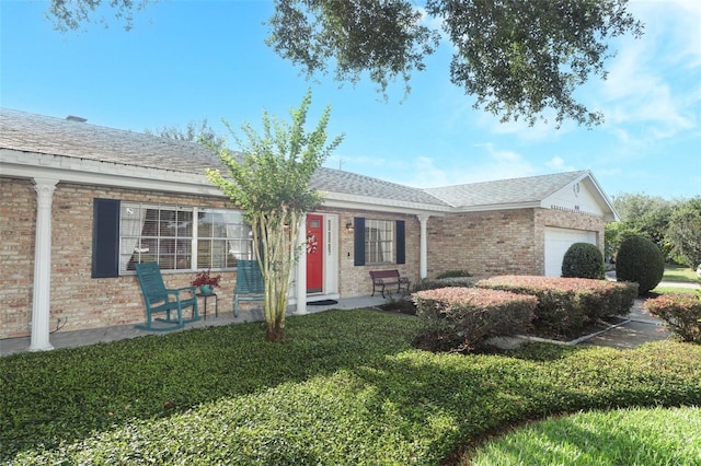 4141 Fallwood Cir, Orlando, FL 32812 - single story home with a garage, brick siding, and covered porch