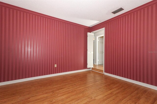 4141 Fallwood Cir, Orlando, FL 32812 - empty room with ornamental molding and wood finished floors