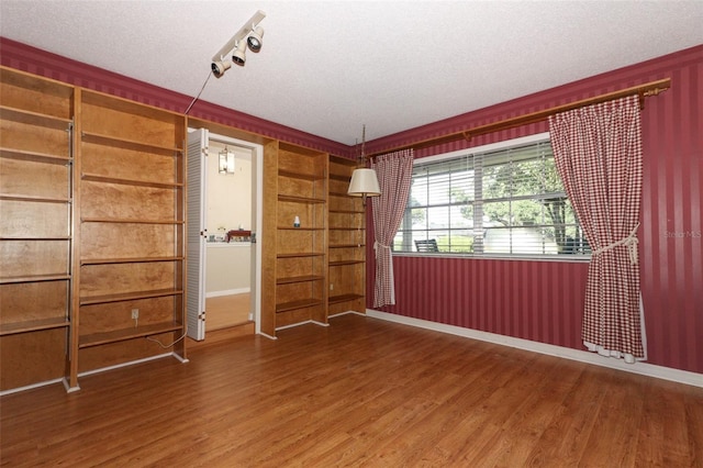 4141 Fallwood Cir, Orlando, FL 32812 - empty room featuring wood finished floors, a textured ceiling, and baseboards