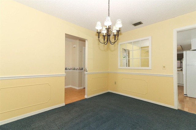 4141 Fallwood Cir, Orlando, FL 32812 - unfurnished room with a chandelier, carpet floors, a textured ceiling, and baseboards
