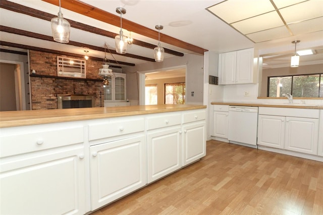 4141 Fallwood Cir, Orlando, FL 32812 - kitchen featuring white dishwasher, light wood-type flooring, light countertops, a sink, and white cabinetry