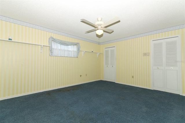 4141 Fallwood Cir, Orlando, FL 32812 - unfurnished bedroom with multiple closets, dark colored carpet, crown molding, and a ceiling fan