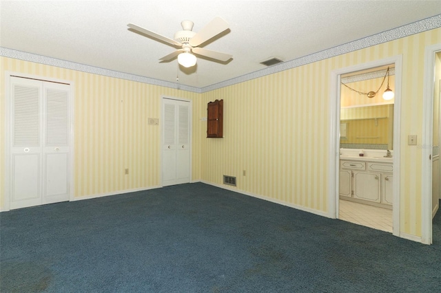4141 Fallwood Cir, Orlando, FL 32812 - unfurnished bedroom with carpet, two closets, crown molding, connected bathroom, and ceiling fan