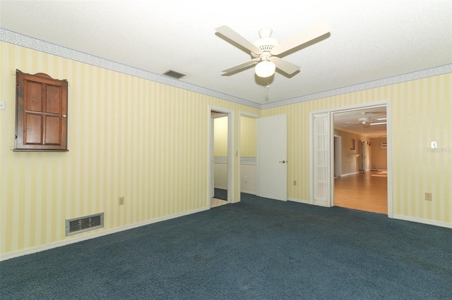 4141 Fallwood Cir, Orlando, FL 32812 - empty room featuring a ceiling fan, wallpapered walls, ornamental molding, and dark carpet