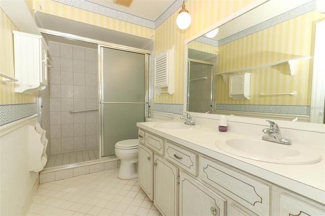 4141 Fallwood Cir, Orlando, FL 32812 - bathroom featuring wallpapered walls, tile patterned flooring, a shower stall, toilet, and double vanity