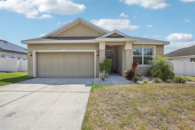 ranch-style house featuring stucco siding, an attached garage, and driveway