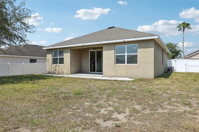 back of house with stucco siding, a patio area, and roof with shingles