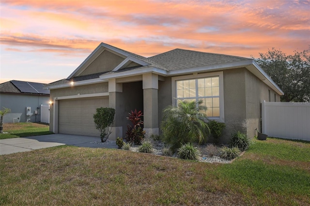 ranch-style house with stucco siding, a garage, concrete driveway, and a shingled roof
