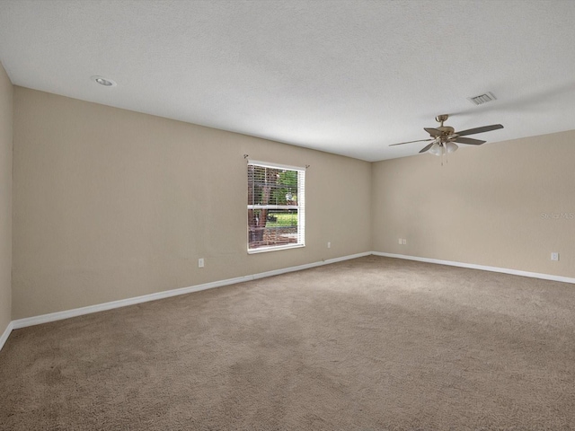 empty room featuring carpet flooring, baseboards, and ceiling fan