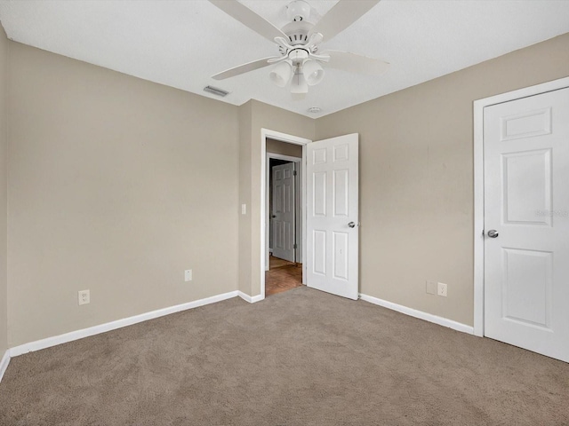 unfurnished bedroom featuring carpet flooring, baseboards, and ceiling fan