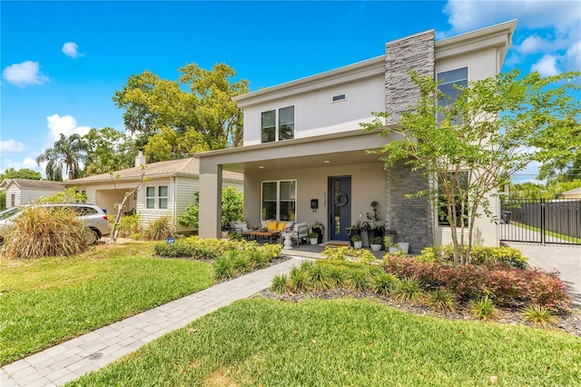 view of front of house featuring an outdoor living space, a front yard, stucco siding, and fence