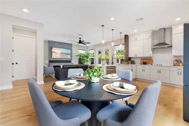 dining area with light wood-style flooring, a ceiling fan, visible vents, and recessed lighting