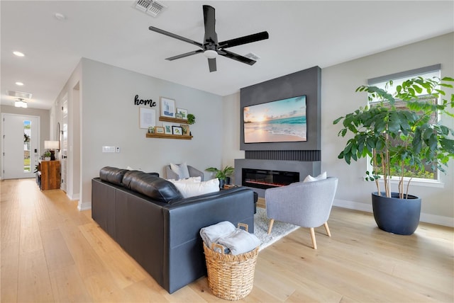 living area with light wood-type flooring, recessed lighting, visible vents, and a ceiling fan