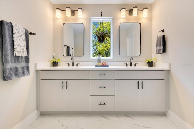 full bathroom featuring a sink, baseboards, and marble finish floor