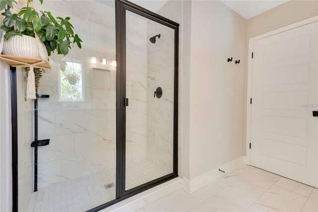 bathroom with a marble finish shower, marble finish floor, and baseboards