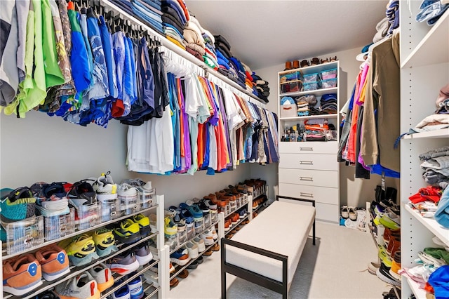 spacious closet featuring carpet flooring