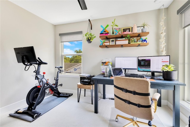 carpeted office space with baseboards