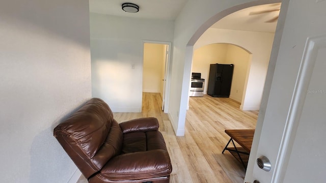 412 Bay St NW, Fort Meade, FL 33841 - sitting room featuring arched walkways, light wood-type flooring, and baseboards