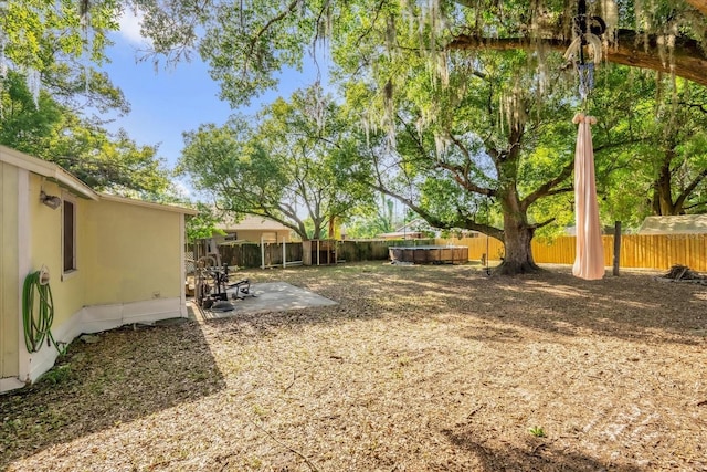 view of yard with a fenced backyard and a patio area