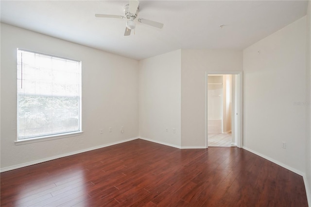spare room with wood finished floors, baseboards, and ceiling fan