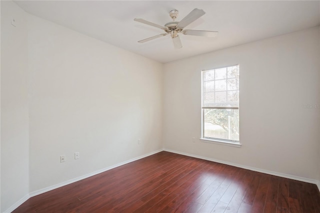 unfurnished room with dark wood-style flooring, baseboards, and plenty of natural light
