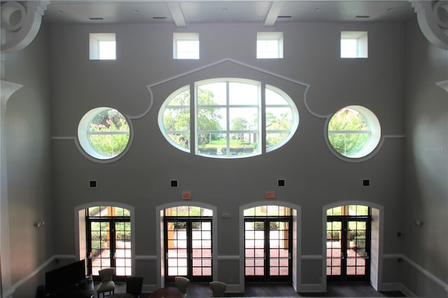 interior space featuring visible vents, french doors, and beam ceiling