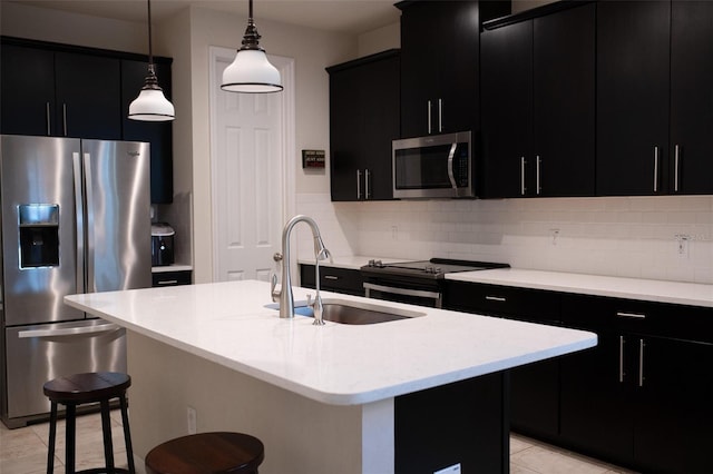 32618 Rapids Loop, Wesley Chapel, FL 33545 - kitchen with dark cabinets, stainless steel appliances, a breakfast bar area, and light countertops