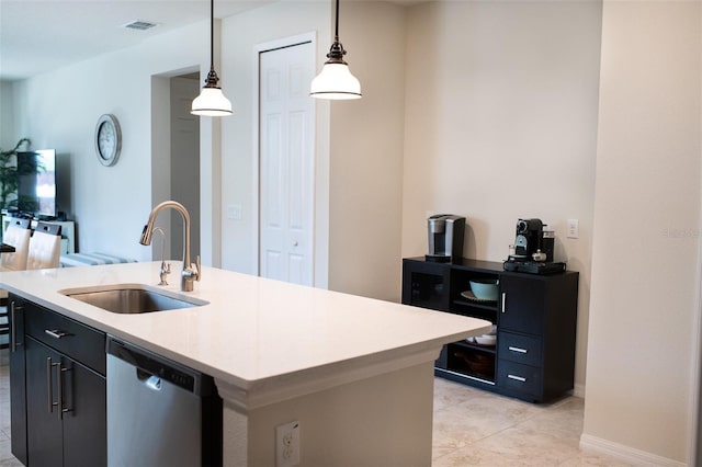 32618 Rapids Loop, Wesley Chapel, FL 33545 - kitchen with a sink, stainless steel dishwasher, hanging light fixtures, light countertops, and a center island with sink