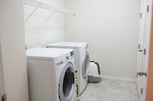32618 Rapids Loop, Wesley Chapel, FL 33545 - clothes washing area with independent washer and dryer, baseboards, and light tile patterned floors