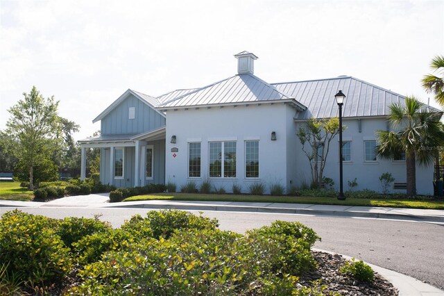 32618 Rapids Loop, Wesley Chapel, FL 33545 - view of front facade featuring a standing seam roof, metal roof, board and batten siding, and stucco siding