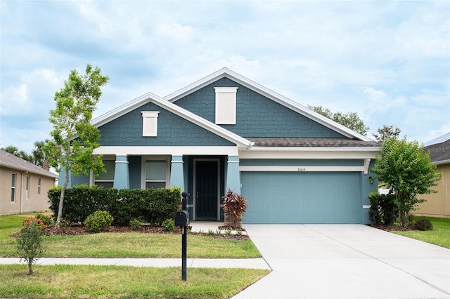 32618 Rapids Loop, Wesley Chapel, FL 33545 - craftsman-style house featuring a garage, driveway, a front yard, and stucco siding