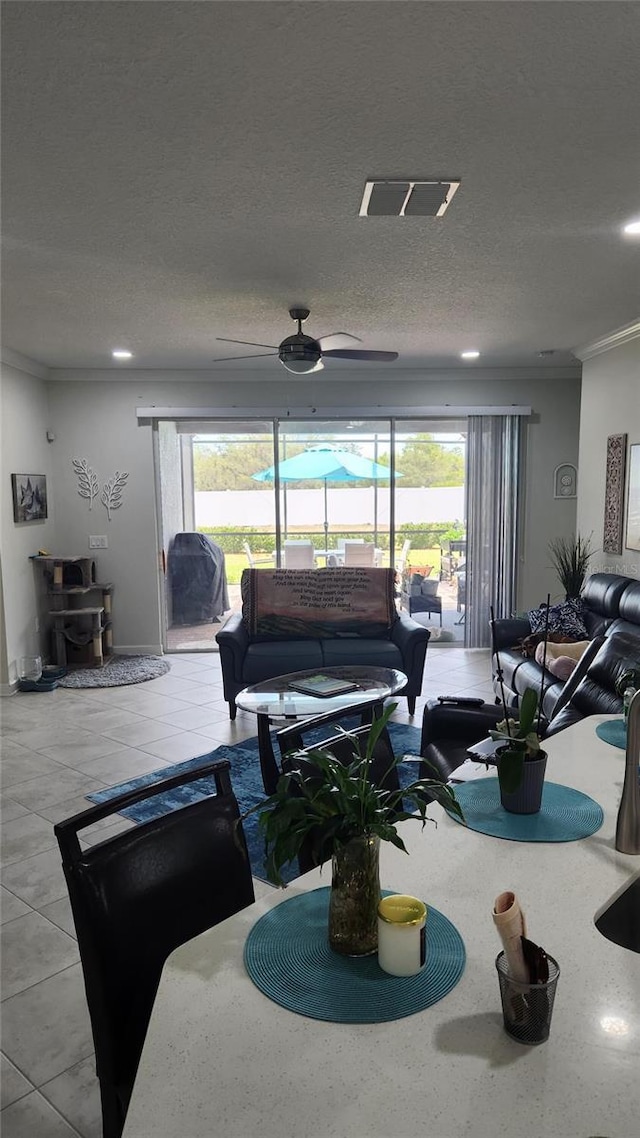 living area featuring ceiling fan, visible vents, ornamental molding, and recessed lighting