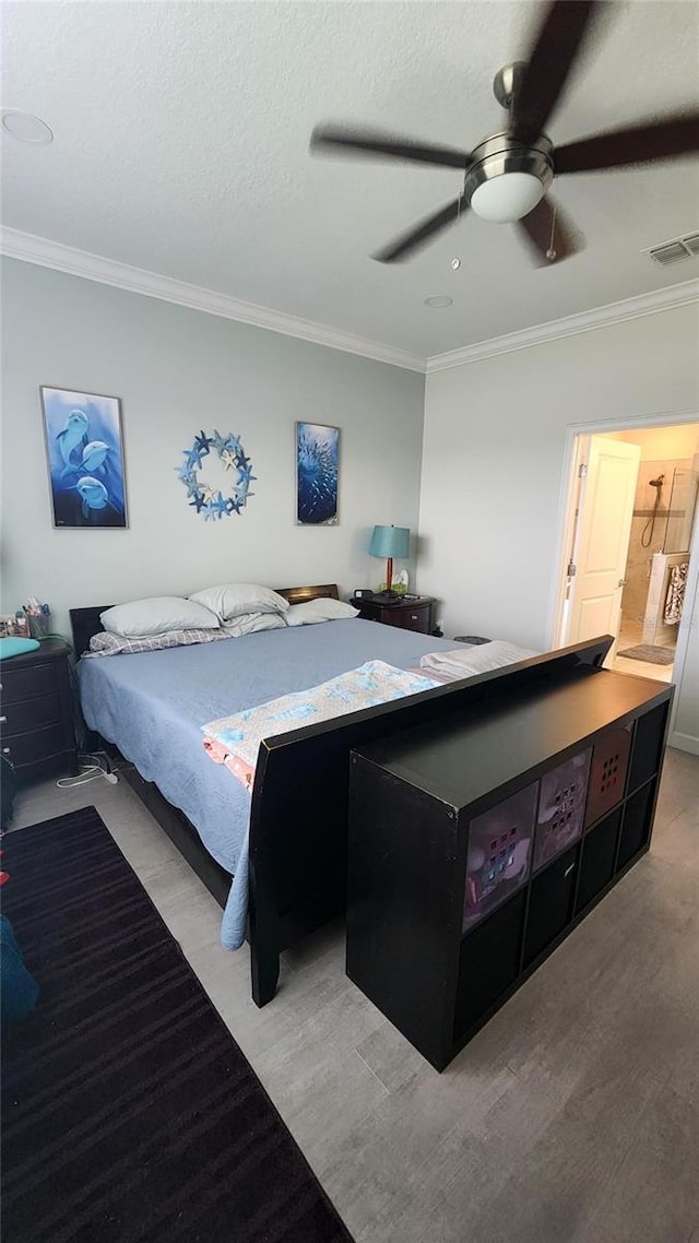 bedroom featuring a ceiling fan, crown molding, and visible vents