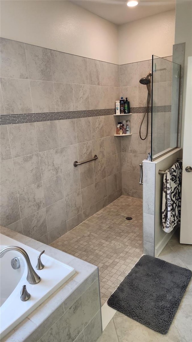 bathroom with a bath and a walk in shower