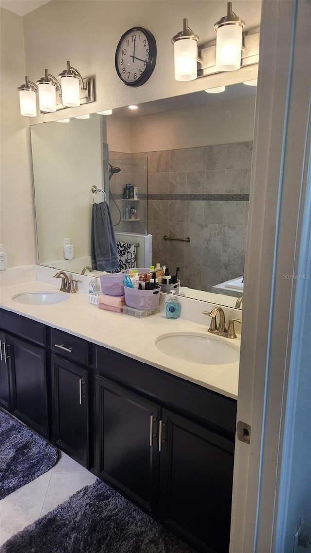 bathroom with a sink, double vanity, and tile patterned floors